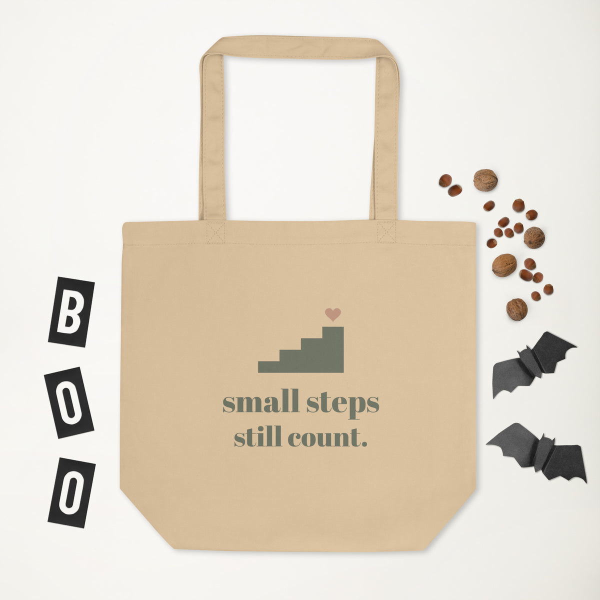 Small Steps Still Count Tote in natural oyster, laid flat with a few small props
