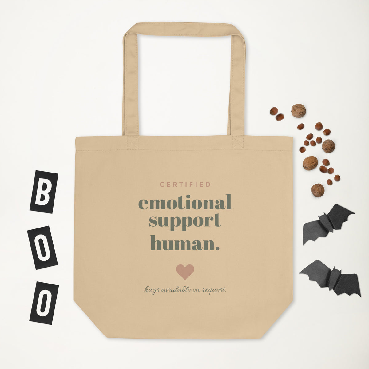 Emotional Support Human Tote in natural oyster, laid flat with a few small props
