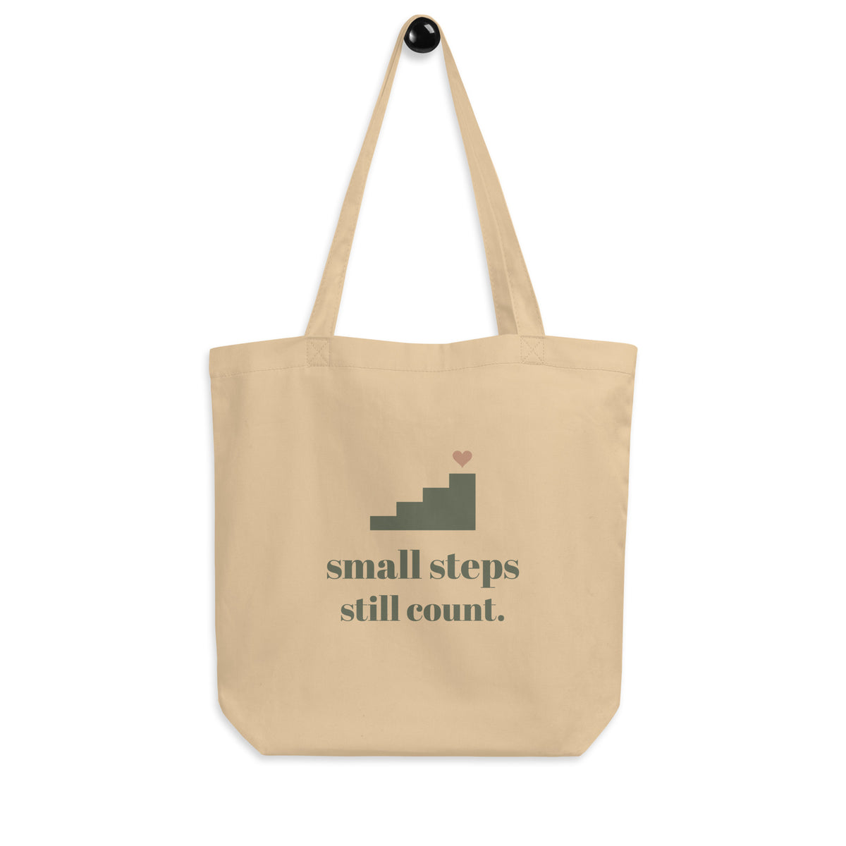 Small Steps Still Count Tote in natural oyster, front view, hanging flat