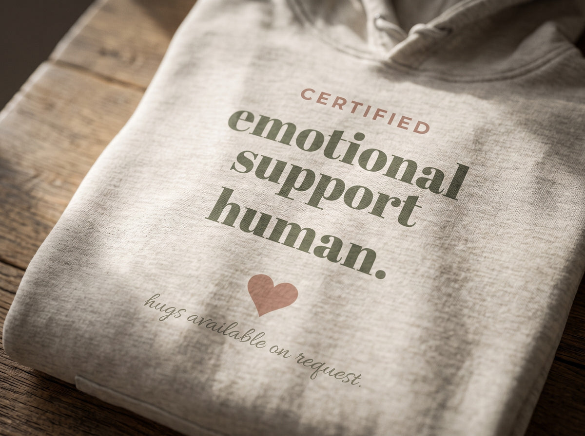 Emotional Support Human Hoodie, the print up close on Oatmeal Heather fleece: CERTIFIED emotional support human., a heart and hugs available on request.