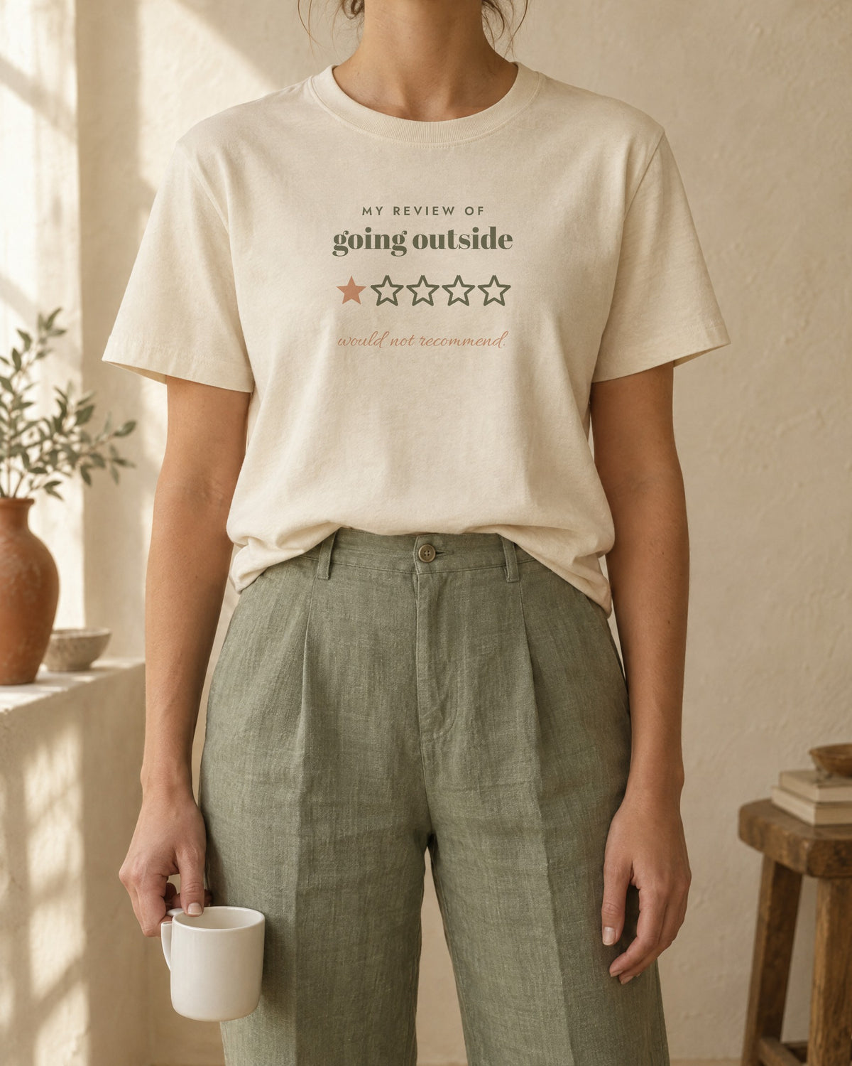 Going Outside, One Star Tee, in soft cream, worn with sage linen trousers