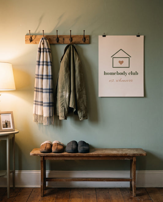Homebody Club Print, unframed, clipped beside the coat hooks