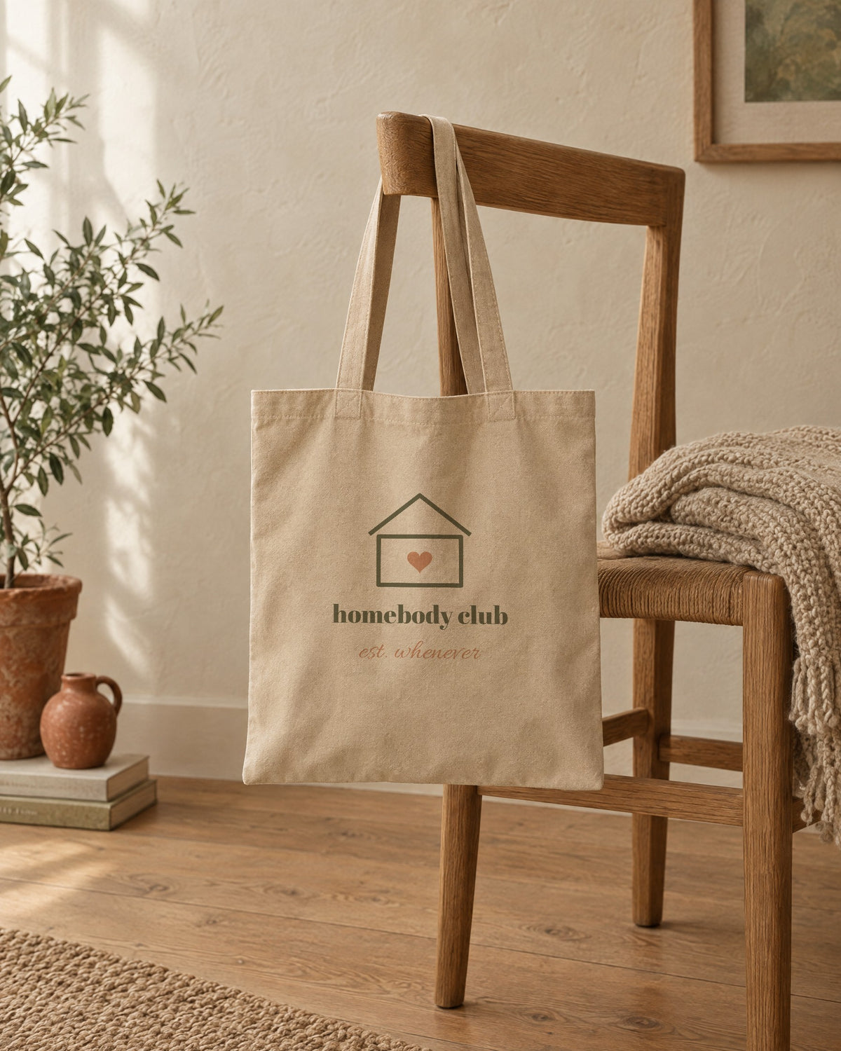 Homebody Club Tote, in natural oyster, hanging on a wooden chair