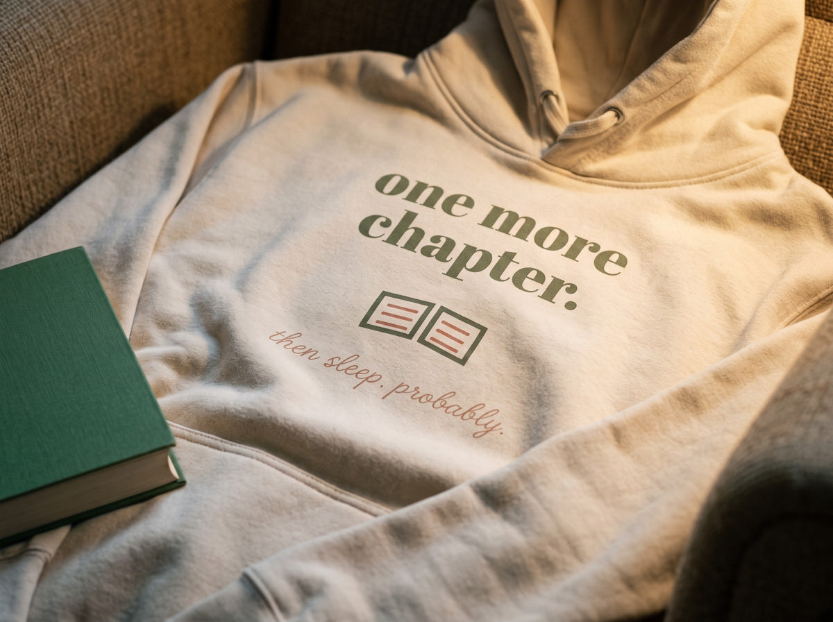 One More Chapter Hoodie, the print up close on Bone fleece: one more chapter., a small open book and then sleep. probably.