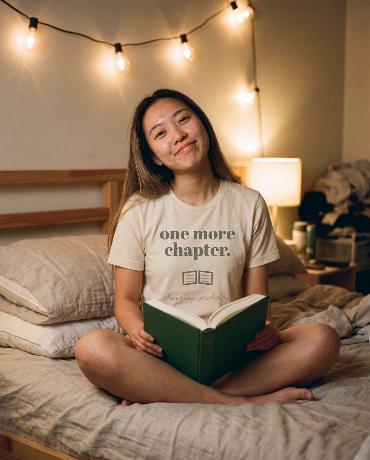 One More Chapter Tee, worn reading in bed under string lights