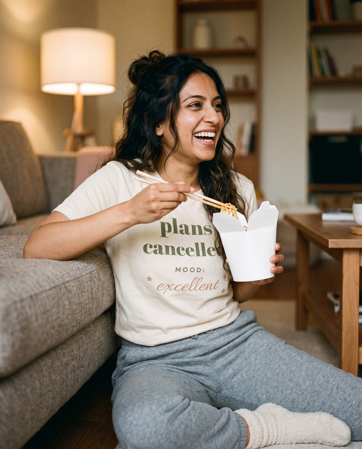 Plans Cancelled Tee, worn with takeaway noodles on the floor
