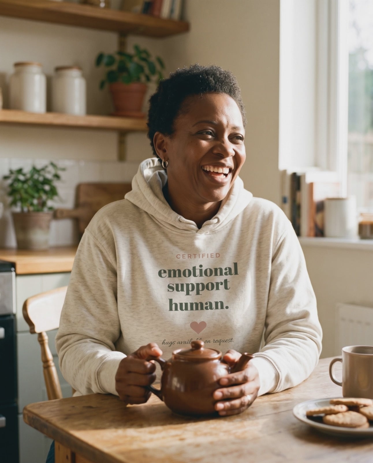 Emotional Support Human Hoodie, a short clip of laughing over a pot of tea in the kitchen