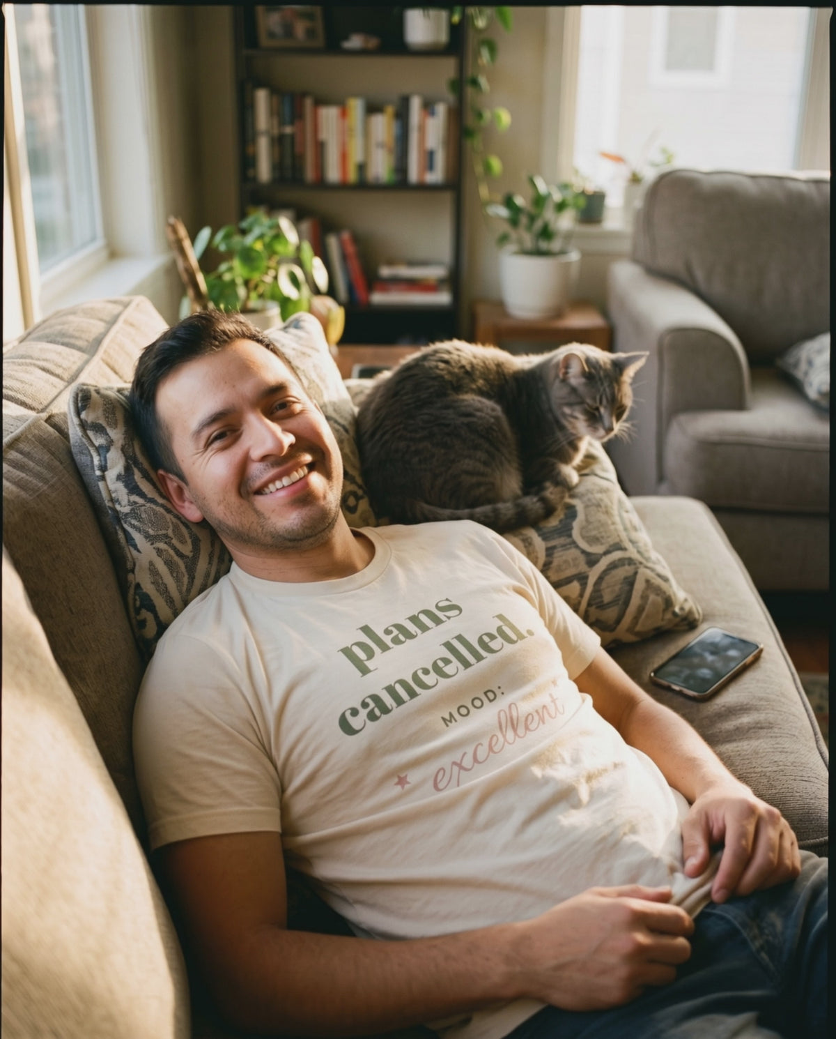 Plans Cancelled Tee, a short clip of lying back on the sofa with a sleeping cat