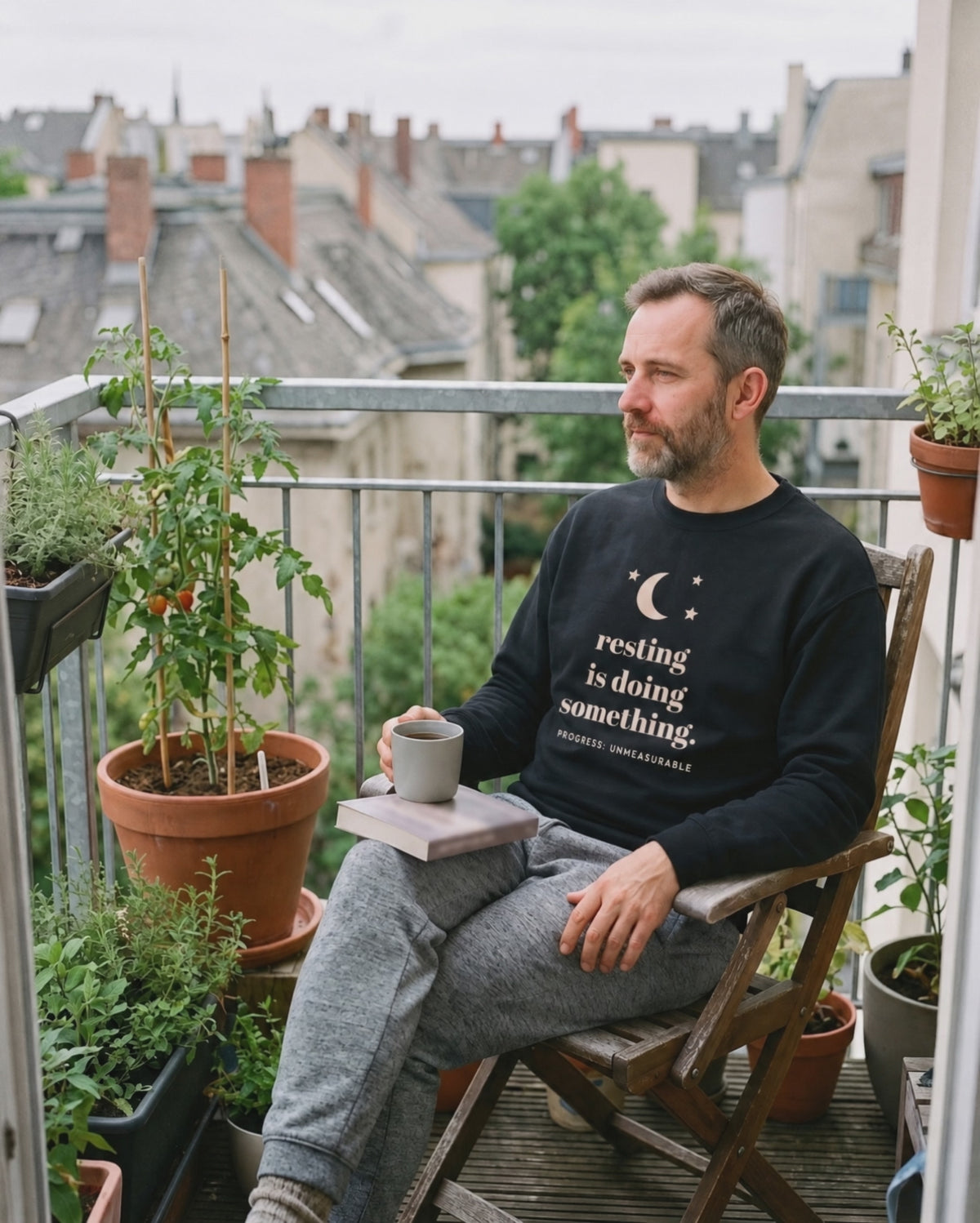 Resting Is Doing Something Crewneck, a short clip of a quiet moment in the sun on a balcony