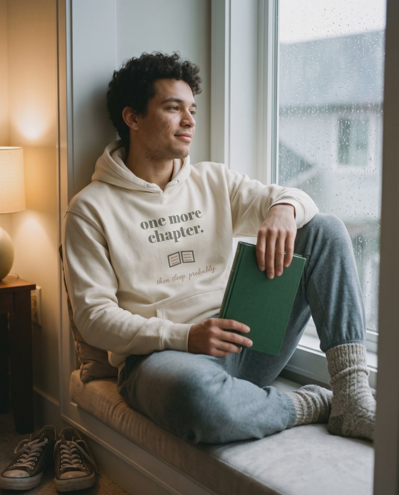 One More Chapter Hoodie, a short clip of opening a book on a window seat on a rainy day