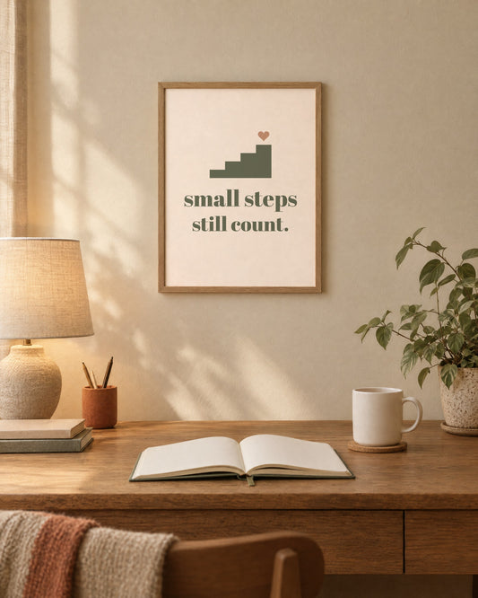 Small Steps Still Count Print, 12 x 16 in matte print, shown framed above a desk (frame not included)