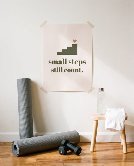 Small Steps Still Count Print, unframed, taped in a home workout corner
