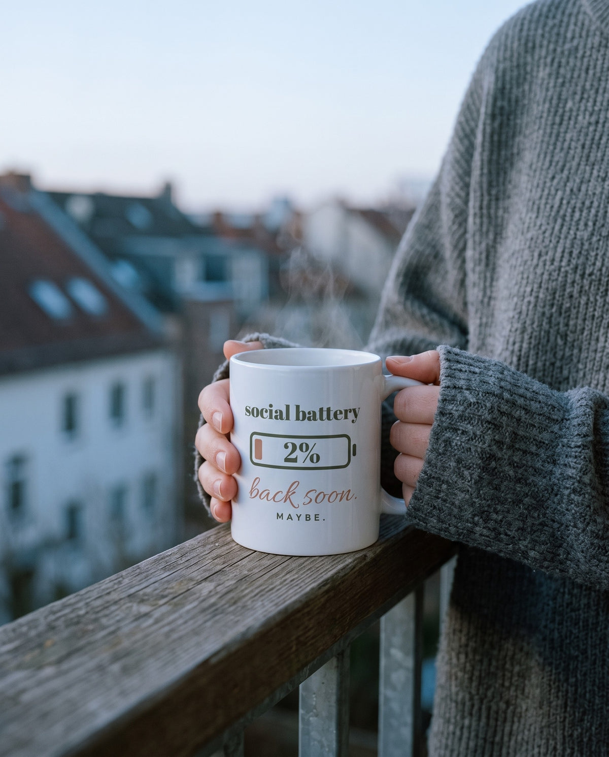 Social Battery Mug, held on a balcony at dawn