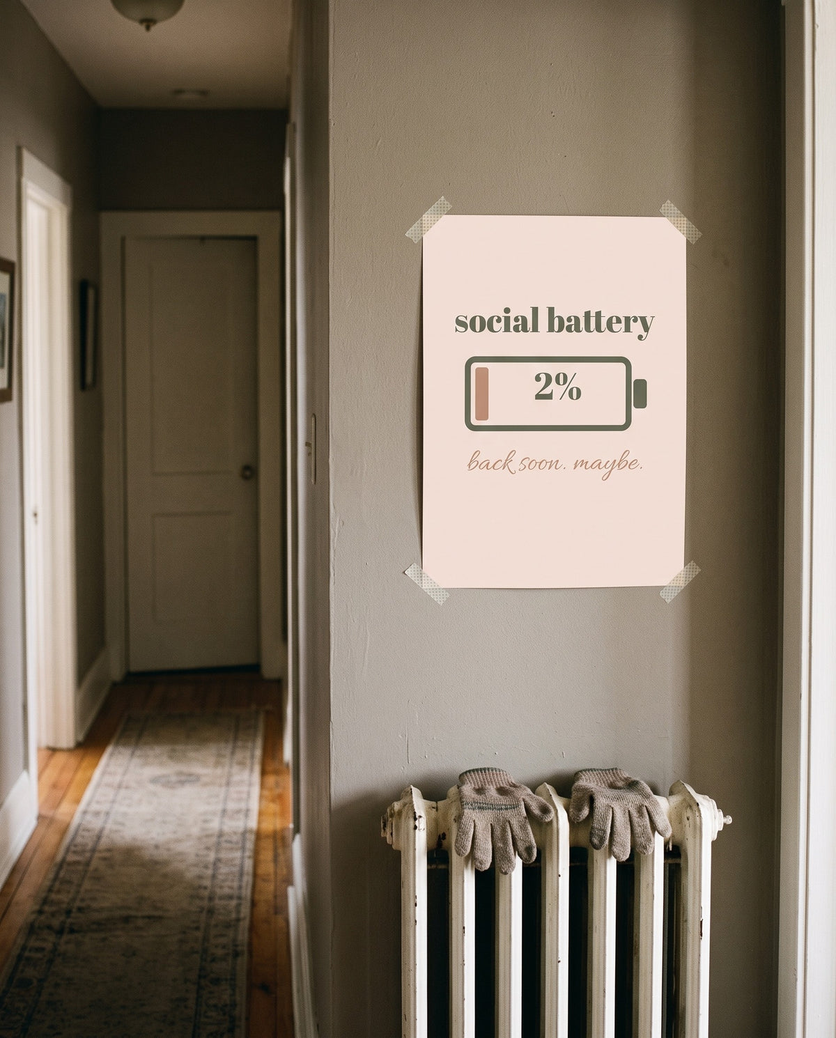 Social Battery Print, unframed, taped in a hallway