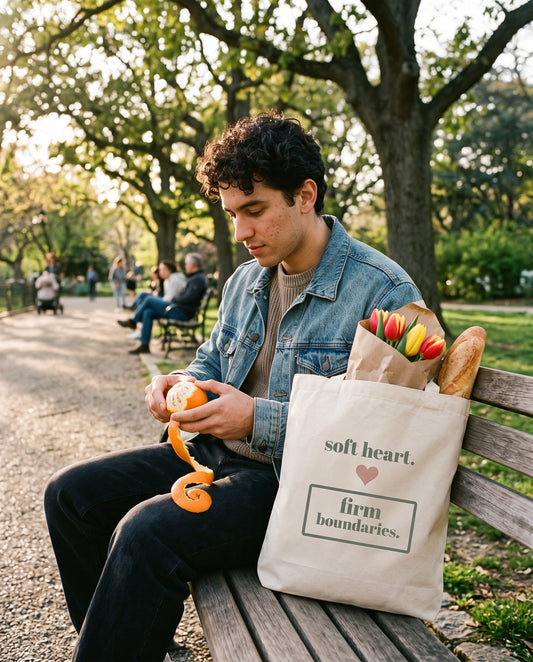 Soft Heart, Firm Boundaries Tote, on a park bench with tulips