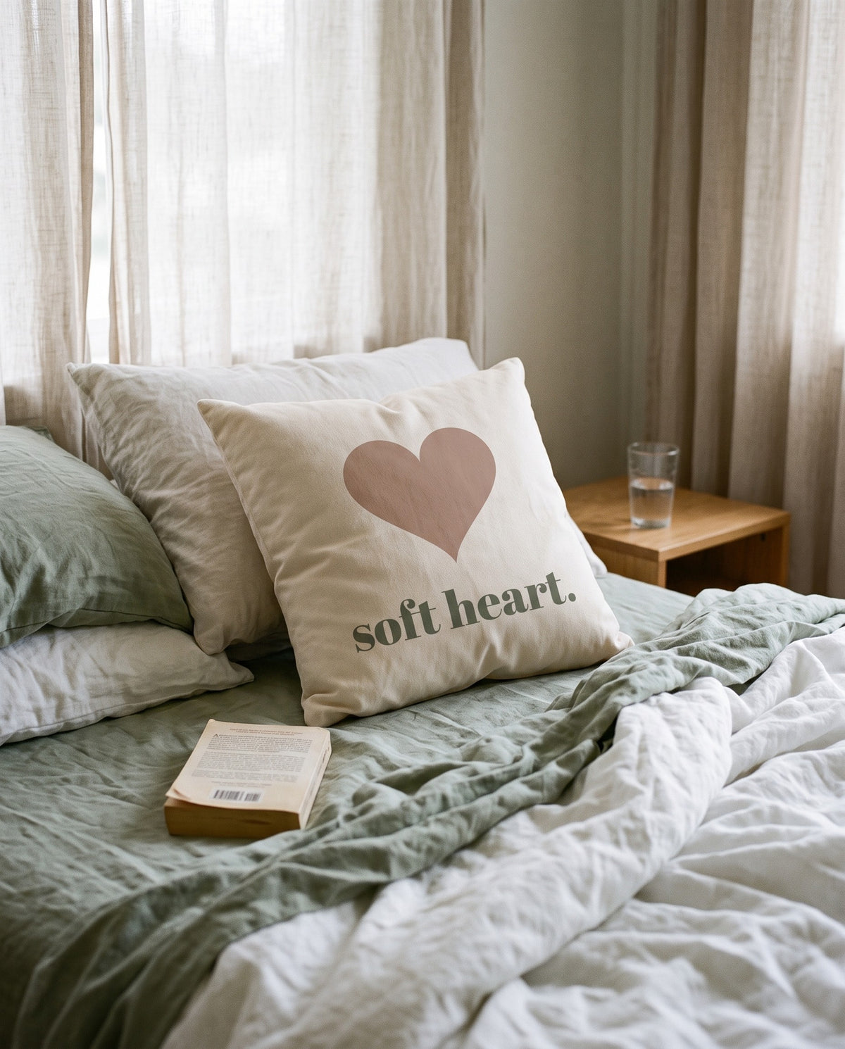 Soft Heart Pillow, on an unmade linen bed