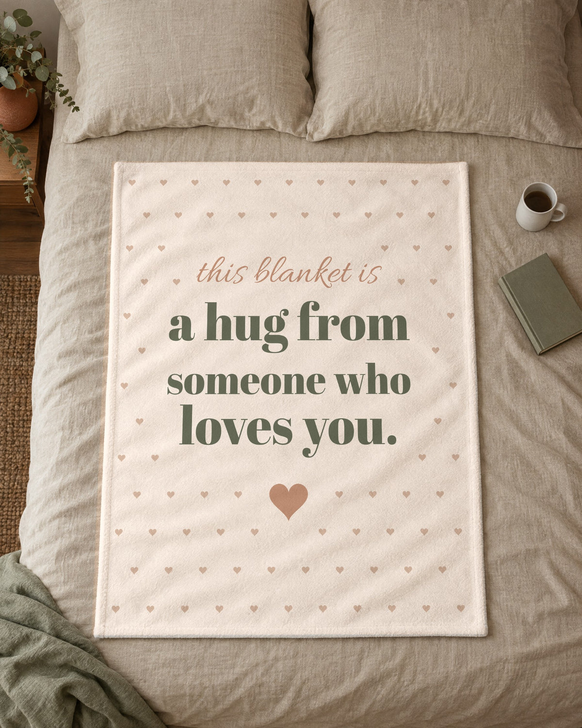 This Blanket Is a Hug Throw, 50 x 60 in, laid flat on a made bed