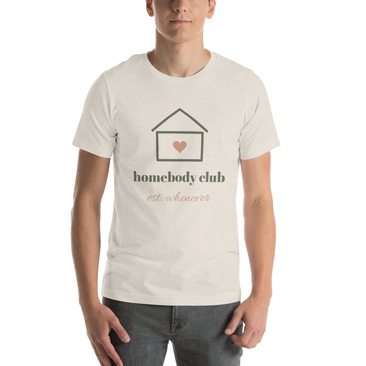 Homebody Club Tee in Heather Dust, worn by a model, front print: a small house with a heart, homebody club, est. whenever