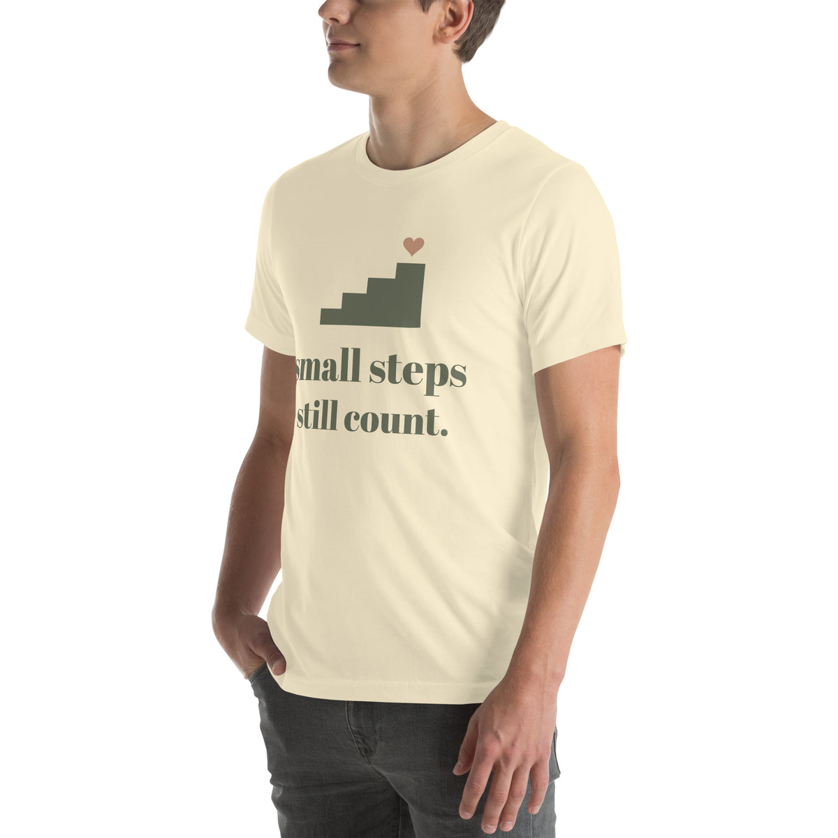 Small Steps Still Count Tee in Natural, worn by a model, three-quarter view from the left